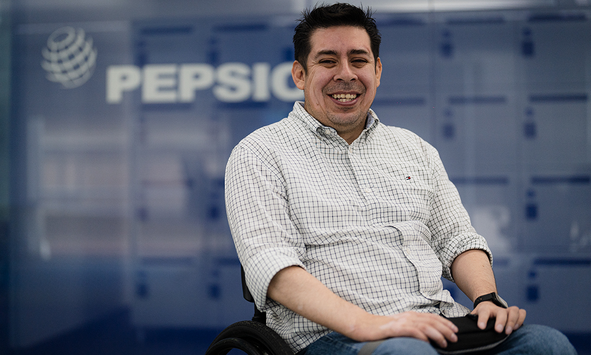 Man sitting in front of PepsiCo sign