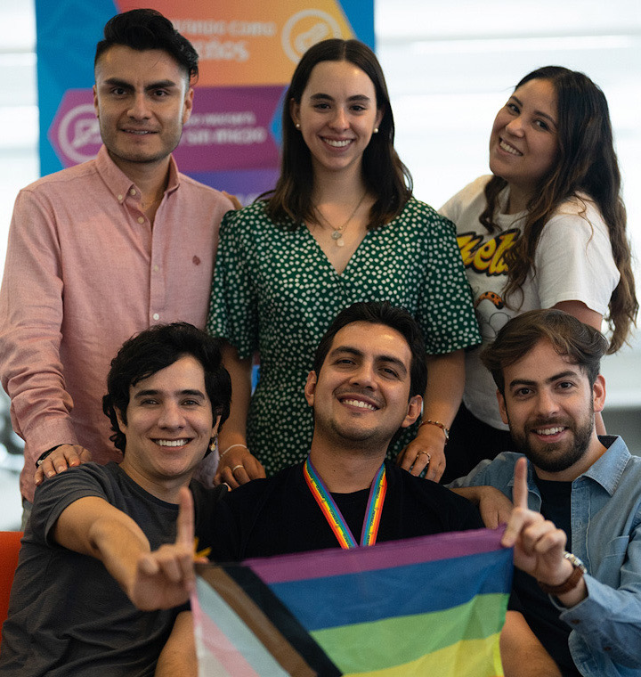 Employees holding a pride flag