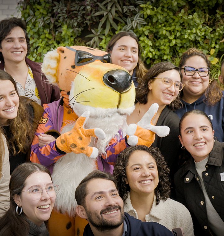 People taking a photo with Chester the Cheetah